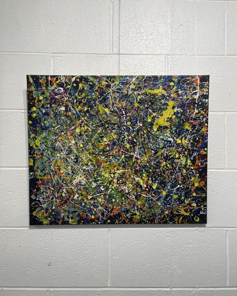 Abstract picture, colours are green, yellow, black and specks of white.