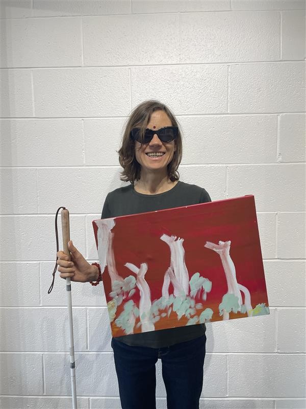 Juliet Jackson Juliet Jackson holding a white cane and red and white painting.