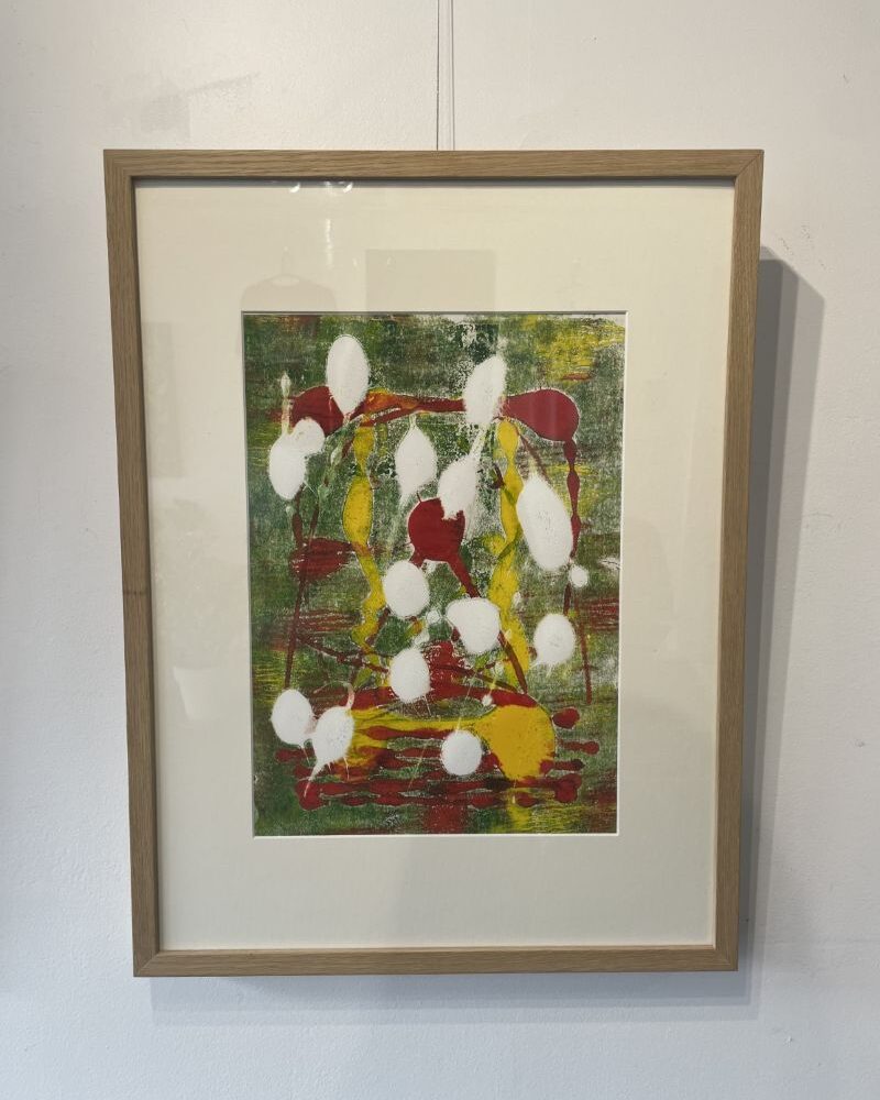 An abstract painting with white, red, and yellow large dots.