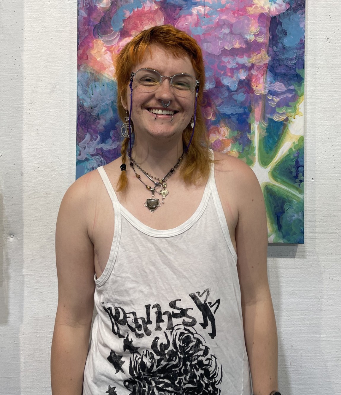 Mars Cook standing in front of a painting