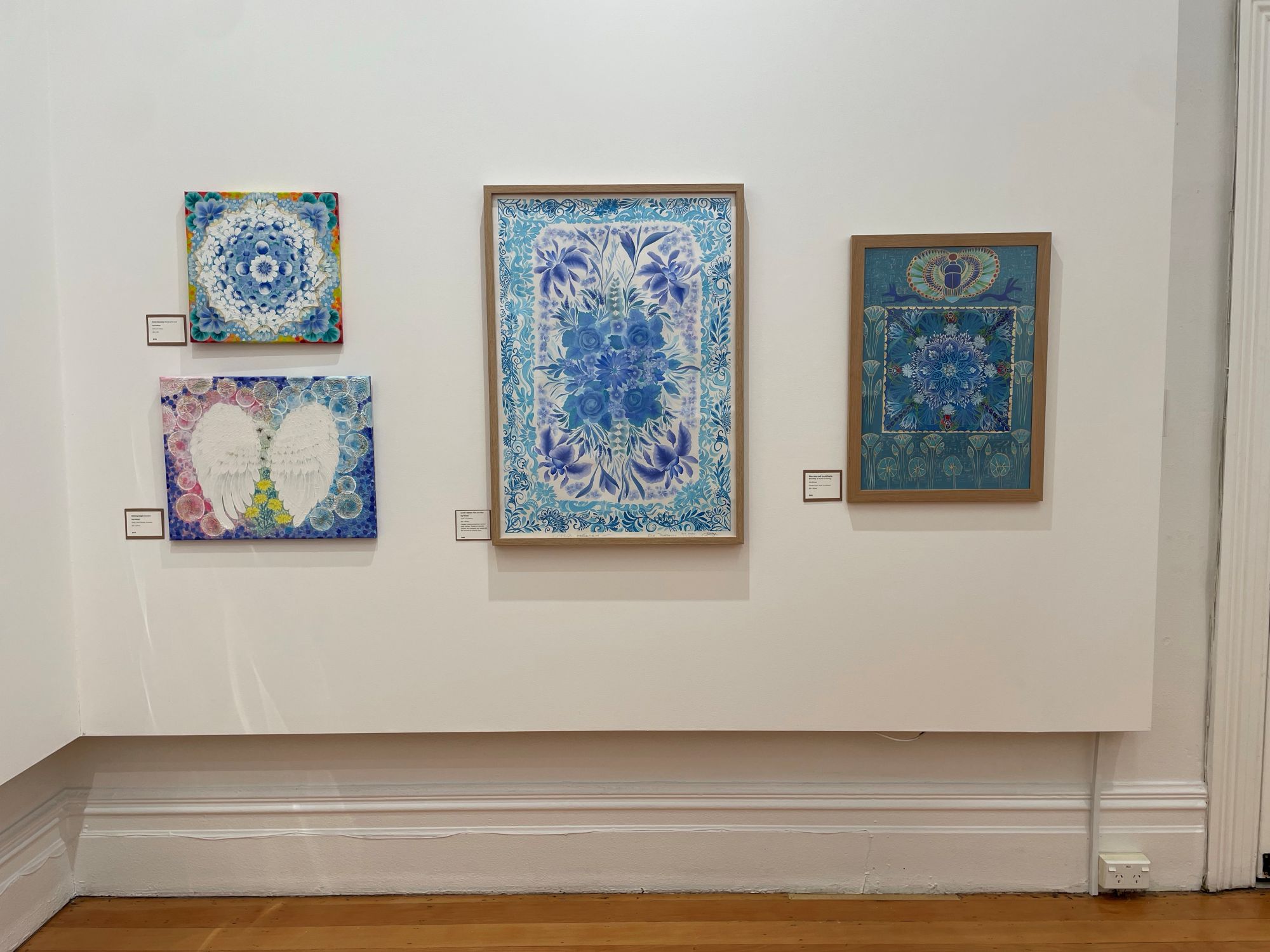 Three of Kay's painting displayed for her exhibition at Studio One Toi Tu